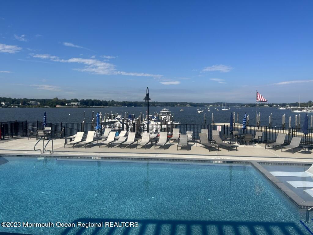 28 Riverside Avenue, Unit 9D Red Bank, NJ 07701 - Photo 4 of 6 a view of a swimming pool with an outdoor seating