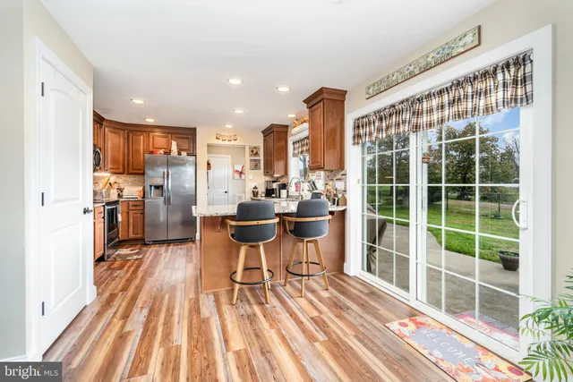 a view of a kitchen with dining room and wooden floor