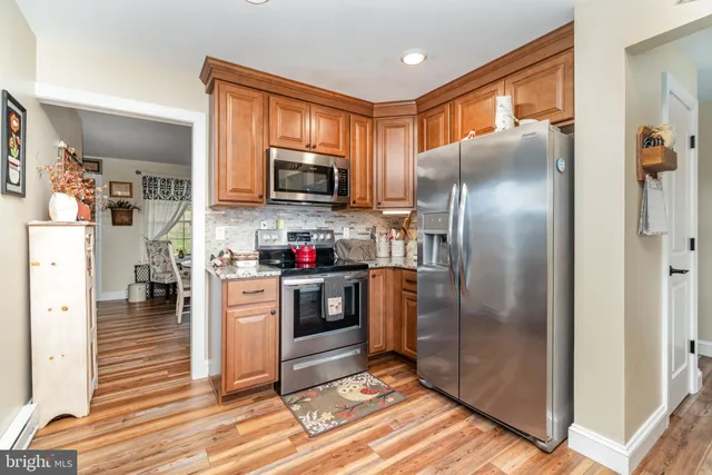 a kitchen with stainless steel appliances granite countertop a refrigerator stove and microwave