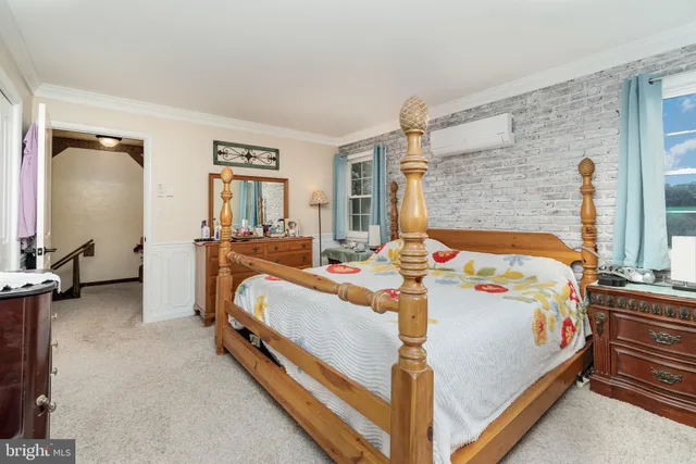 a bed room with a bed and a chair