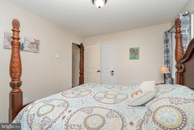 a bedroom with a bed and a mirror