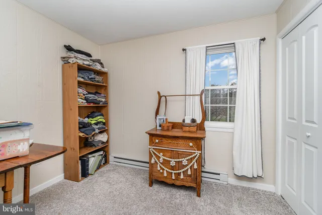 a room with furniture a rug and a window