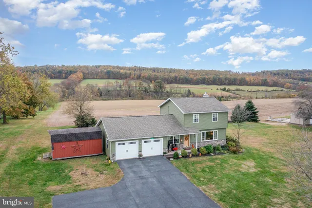 an aerial view of a house with big yard