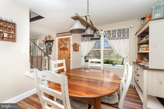 a dining room with furniture and wooden floor