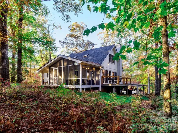 a front view of house with large trees