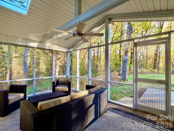 a white house that has a tree in front of it