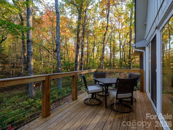 a white house that has a tree in front of it