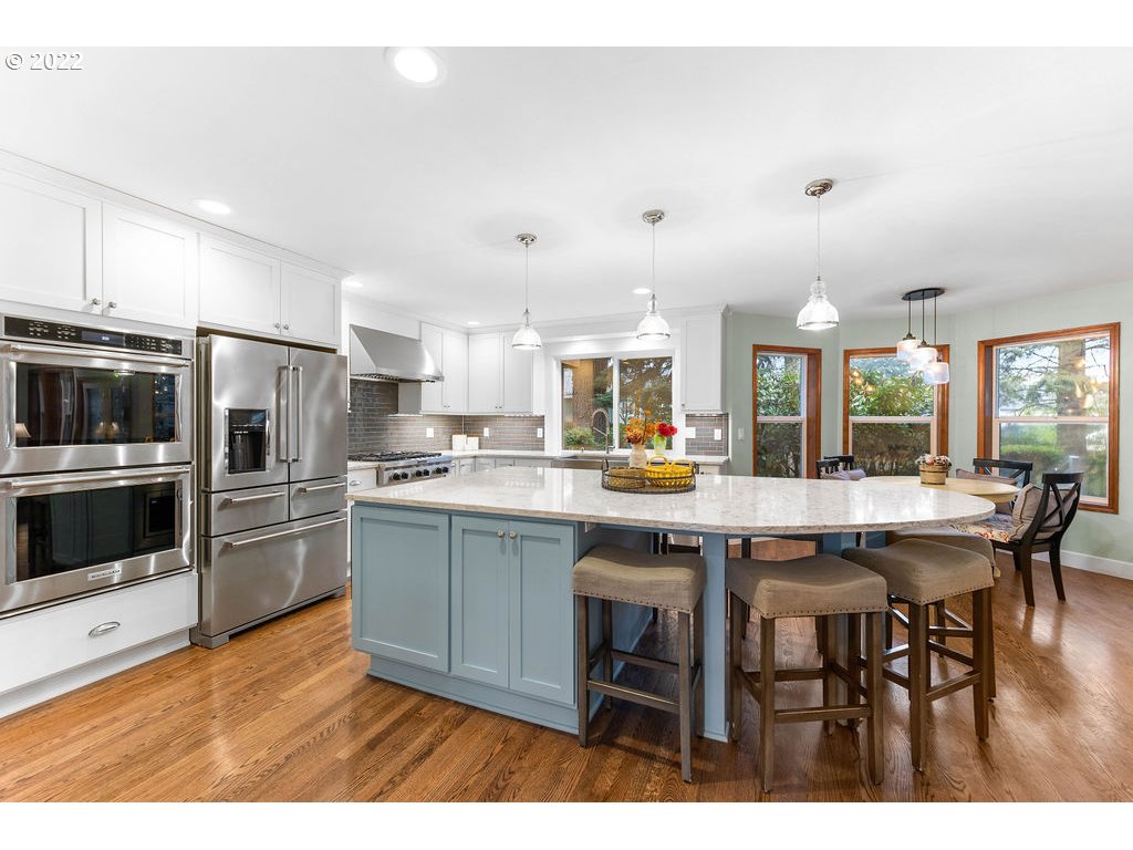 20010 Southeast 3rd Circle Camas, WA 98607 - Photo 11 of 28 a kitchen with stainless steel appliances kitchen island granite countertop a table chairs sink and cabinets