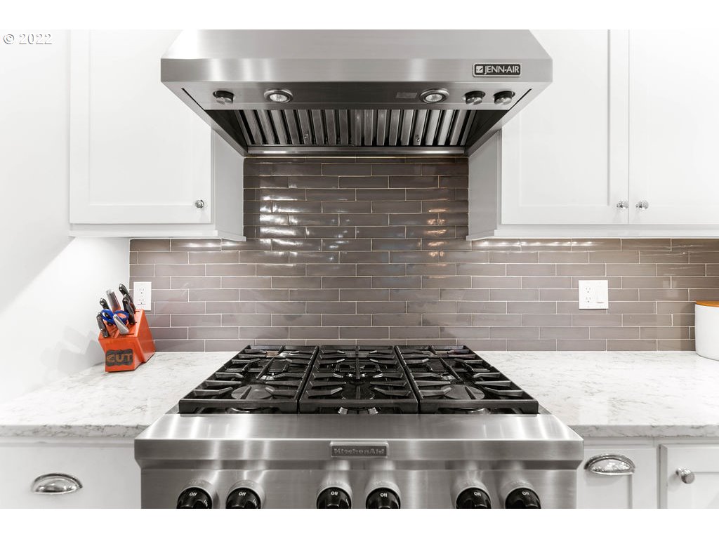20010 Southeast 3rd Circle Camas, WA 98607 - Photo 15 of 28 a kitchen with granite countertop a stove a sink and white cabinets