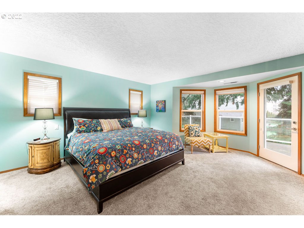 20010 Southeast 3rd Circle Camas, WA 98607 - Photo 21 of 28 a bedroom with a bed and glass door