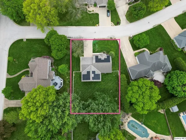 an aerial view of a house with garden space and street view