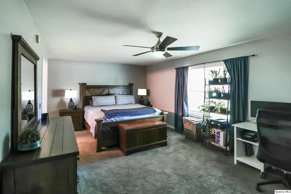 a bed room with a bed and a television