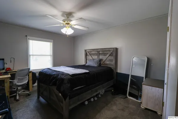 a bedroom with a bed and a chandelier