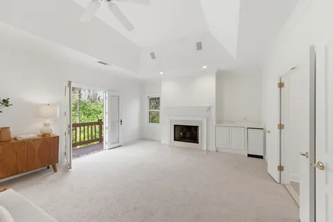 a view of an empty room with a fireplace and a window