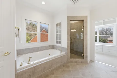 a bathroom with a bathtub and a shower