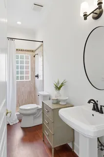 a bathroom with a sink a toilet and tub