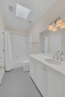 a bathroom with a bathtub a sink a toilet and a mirror