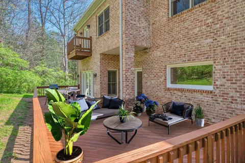 a view of a house with backyard and sitting area