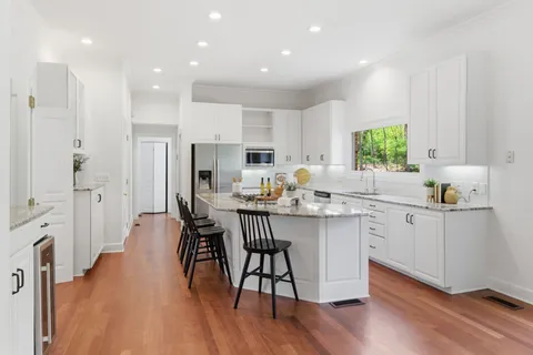a kitchen with a sink appliances and cabinets