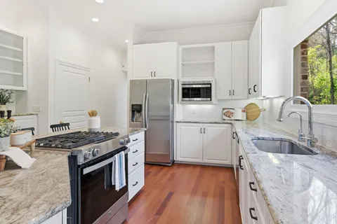 a kitchen with a stove a sink and a refrigerator