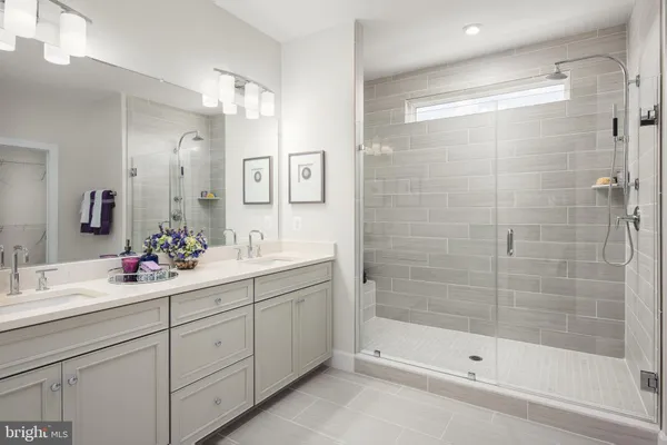 a bathroom with a shower sink and mirror