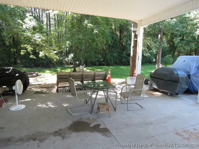 a view of balcony with wooden floor and trees