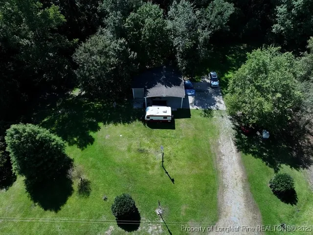 an aerial view of a house with a yard