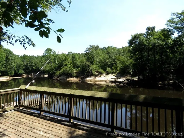 a view of patio with a table and chairs under an umbrella