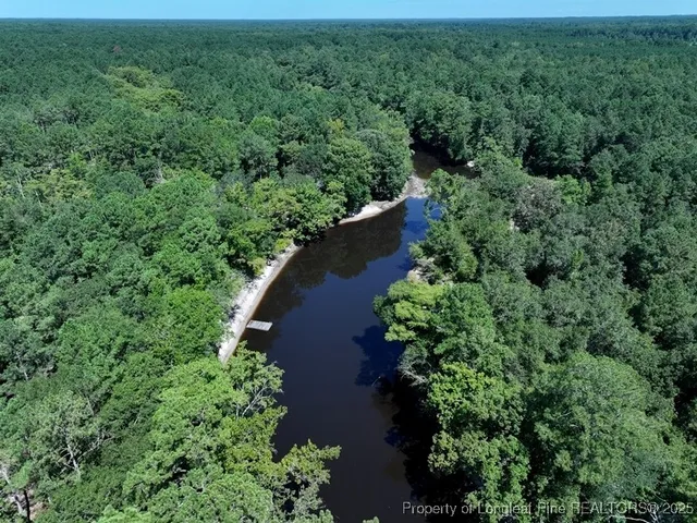 an aerial view of a houses with yard