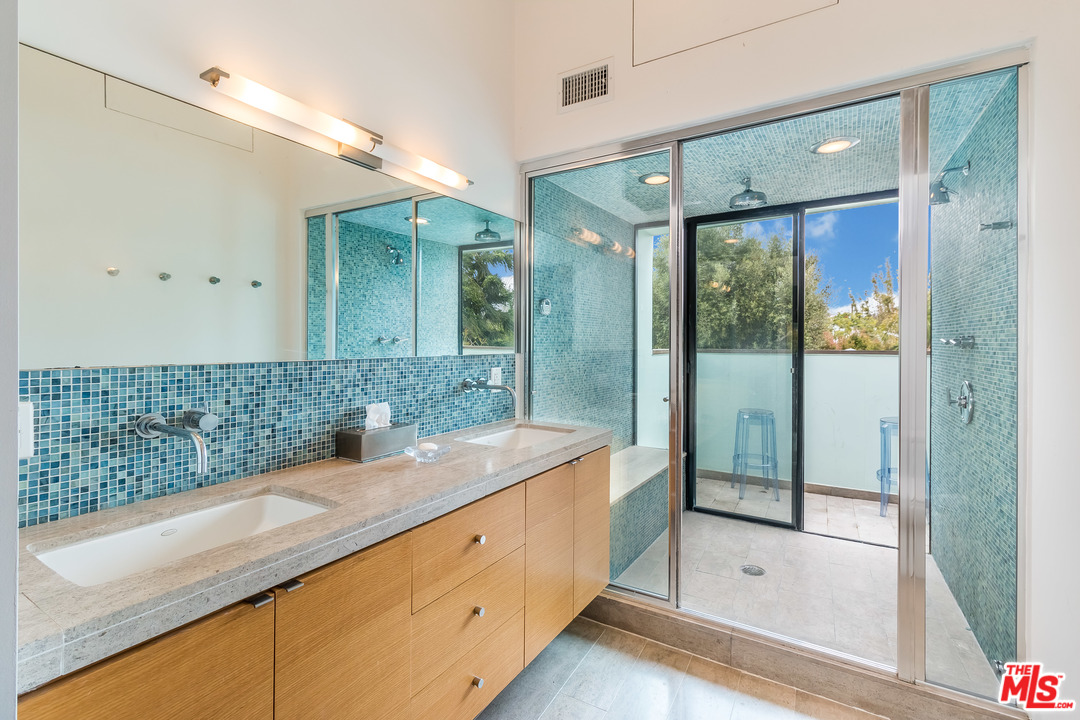 631 Palms Boulevard Venice, CA 90291 - Photo 15 of 23 a bathroom with a granite countertop sink mirror and shower