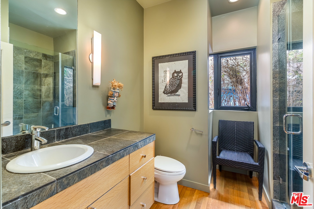 631 Palms Boulevard Venice, CA 90291 - Photo 17 of 23 a bathroom with a granite countertop toilet a sink and a mirror