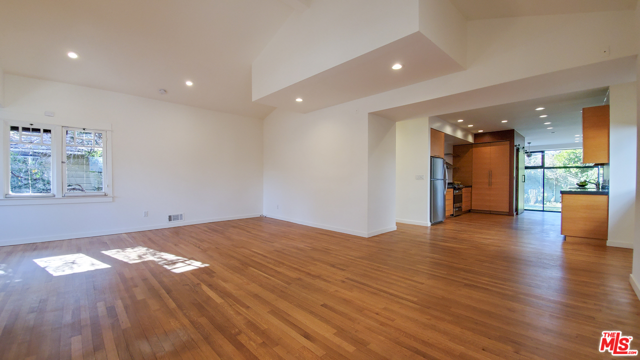 631 Palms Boulevard Venice, CA 90291 - Photo 8 of 23 a view of an empty room with wooden floor and a kitchen