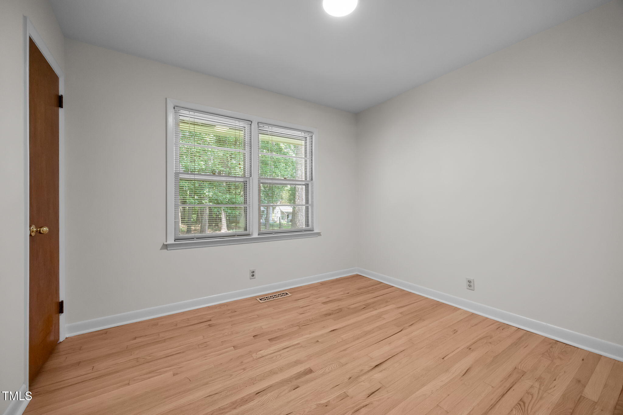 2809 Bardwell Road Raleigh, NC 27604 - Photo 13 of 19 an empty room with wooden floor and windows