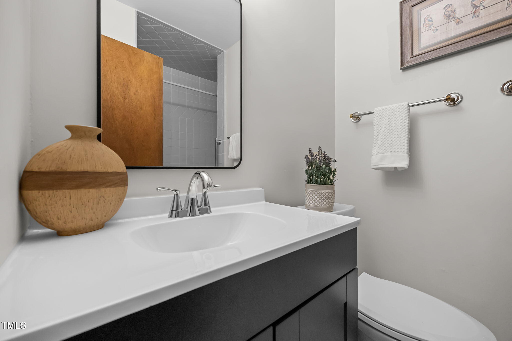 2809 Bardwell Road Raleigh, NC 27604 - Photo 14 of 19 a bathroom with a sink a toilet and mirror