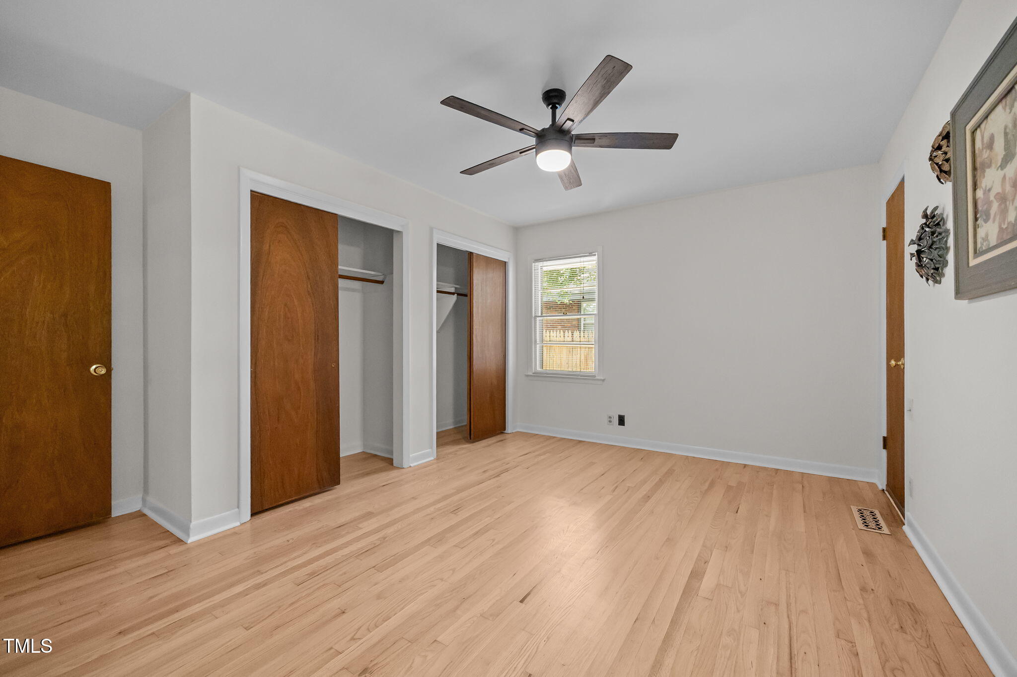 2809 Bardwell Road Raleigh, NC 27604 - Photo 10 of 19 a view of an empty room with wooden floor and a window