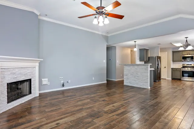 a view of a kitchen with a sink and a fireplace