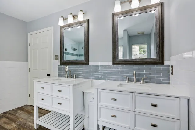 a bathroom with a tub sink and mirror