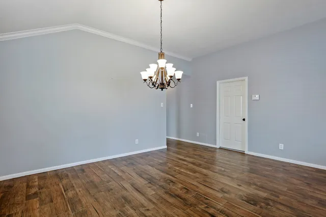 a view of a chandelier in big room and chandelier fan