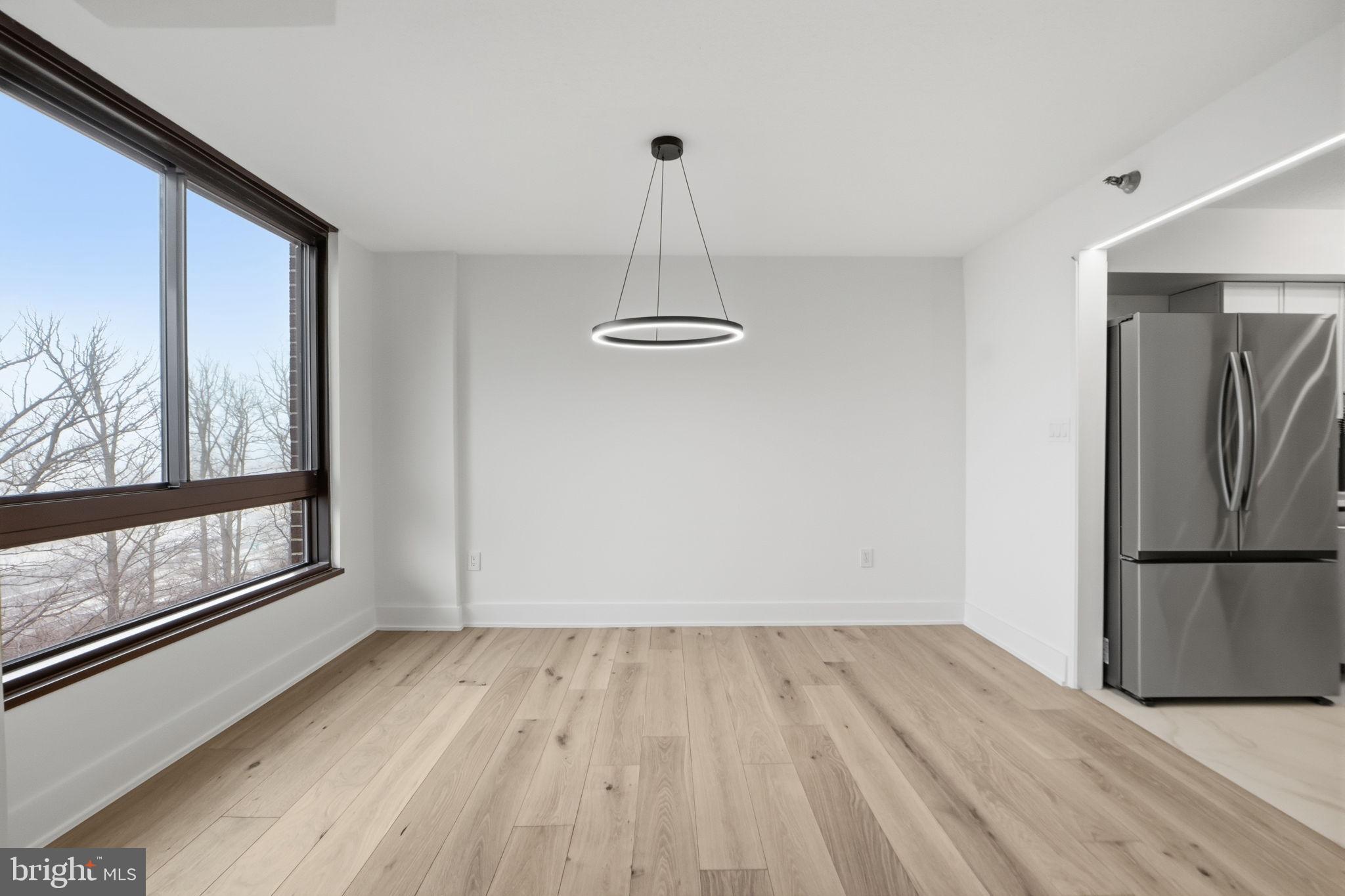 1808 Old Meadow Road, Unit 1201 McLean, VA 22102 - Photo 11 of 37 a view of empty room with wooden floor and fan