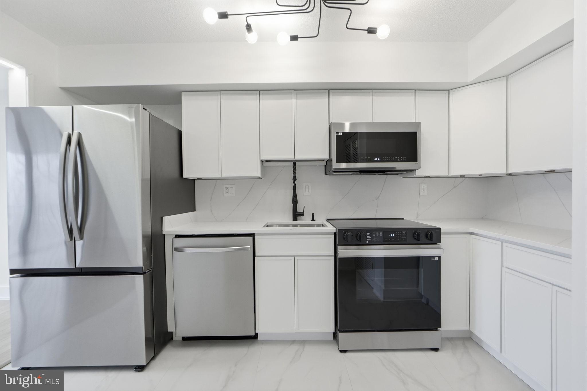1808 Old Meadow Road, Unit 1201 McLean, VA 22102 - Photo 14 of 37 a kitchen with a refrigerator stove and microwave