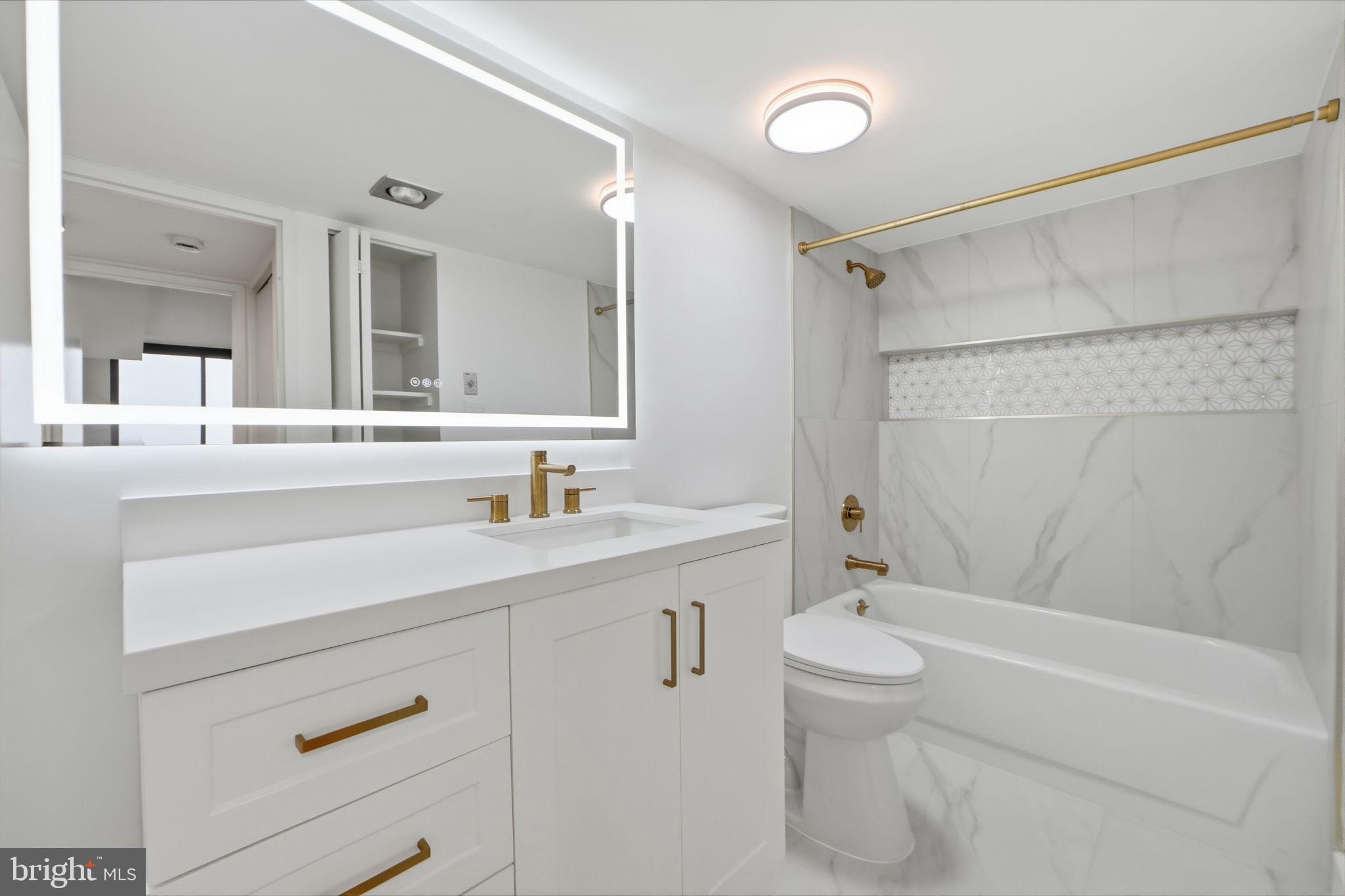 1808 Old Meadow Road, Unit 1201 McLean, VA 22102 - Photo 17 of 37 a bathroom with a sink a toilet and shower
