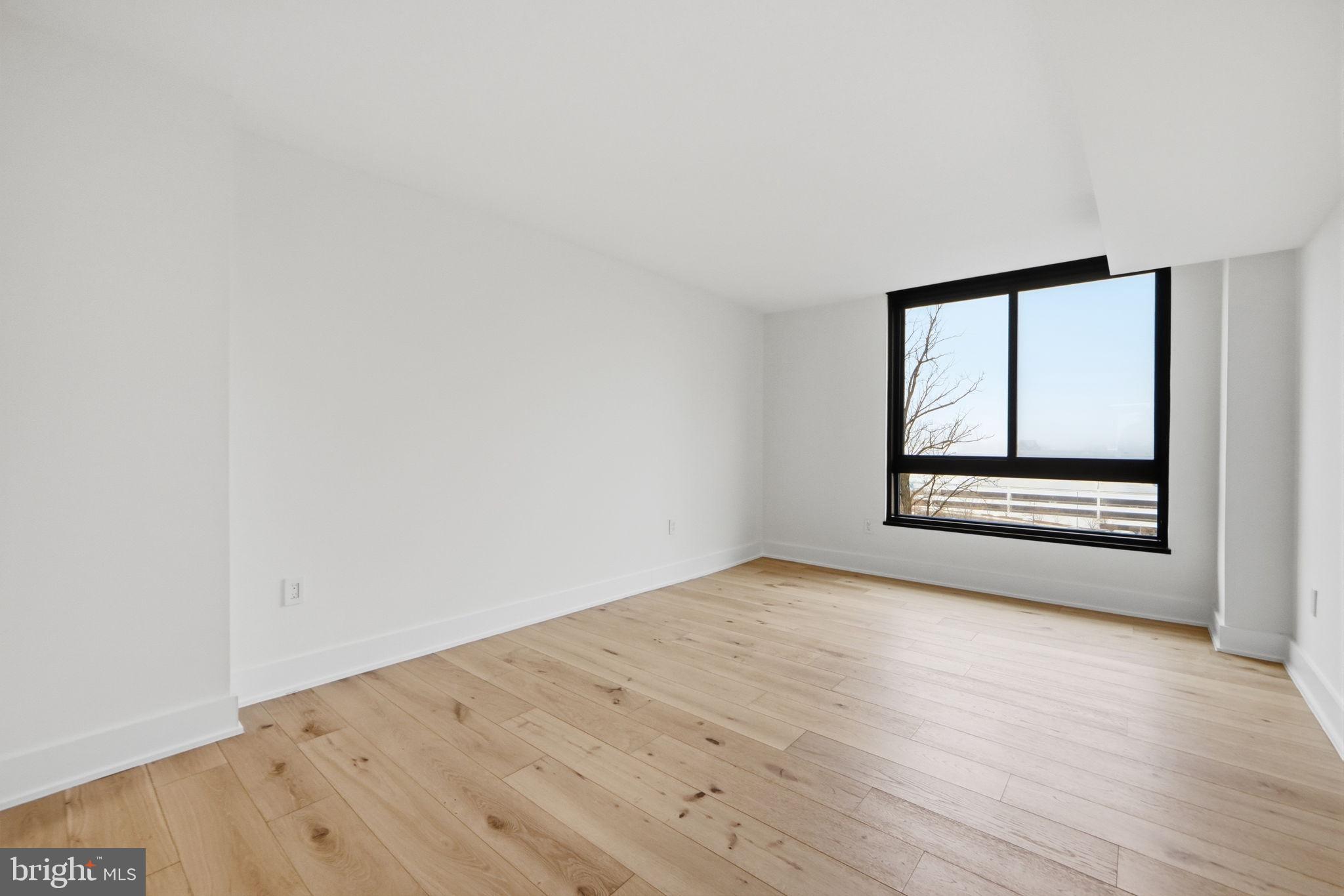 1808 Old Meadow Road, Unit 1201 McLean, VA 22102 - Photo 18 of 37 wooden floor in an empty room with a window