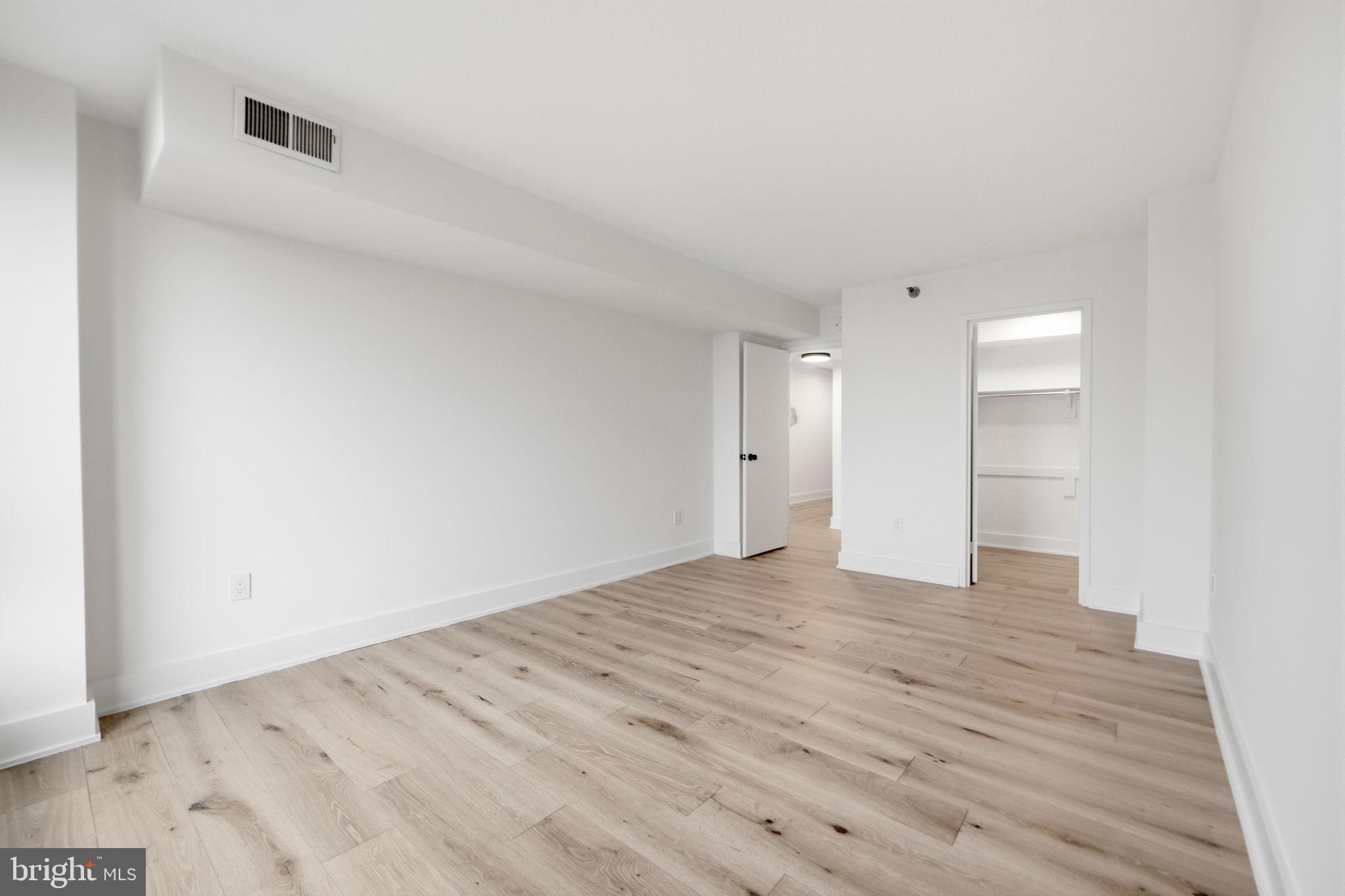 1808 Old Meadow Road, Unit 1201 McLean, VA 22102 - Photo 21 of 37 a view of an empty room with wooden floor and a window