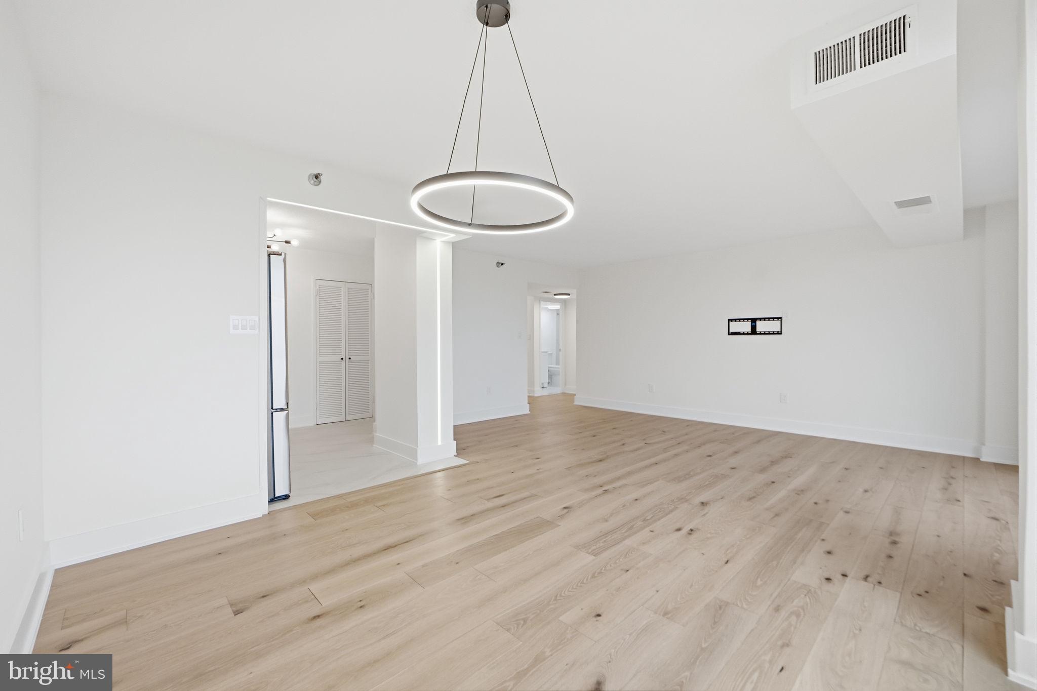 1808 Old Meadow Road, Unit 1201 McLean, VA 22102 - Photo 23 of 37 a view of a room with wooden floor and white walls