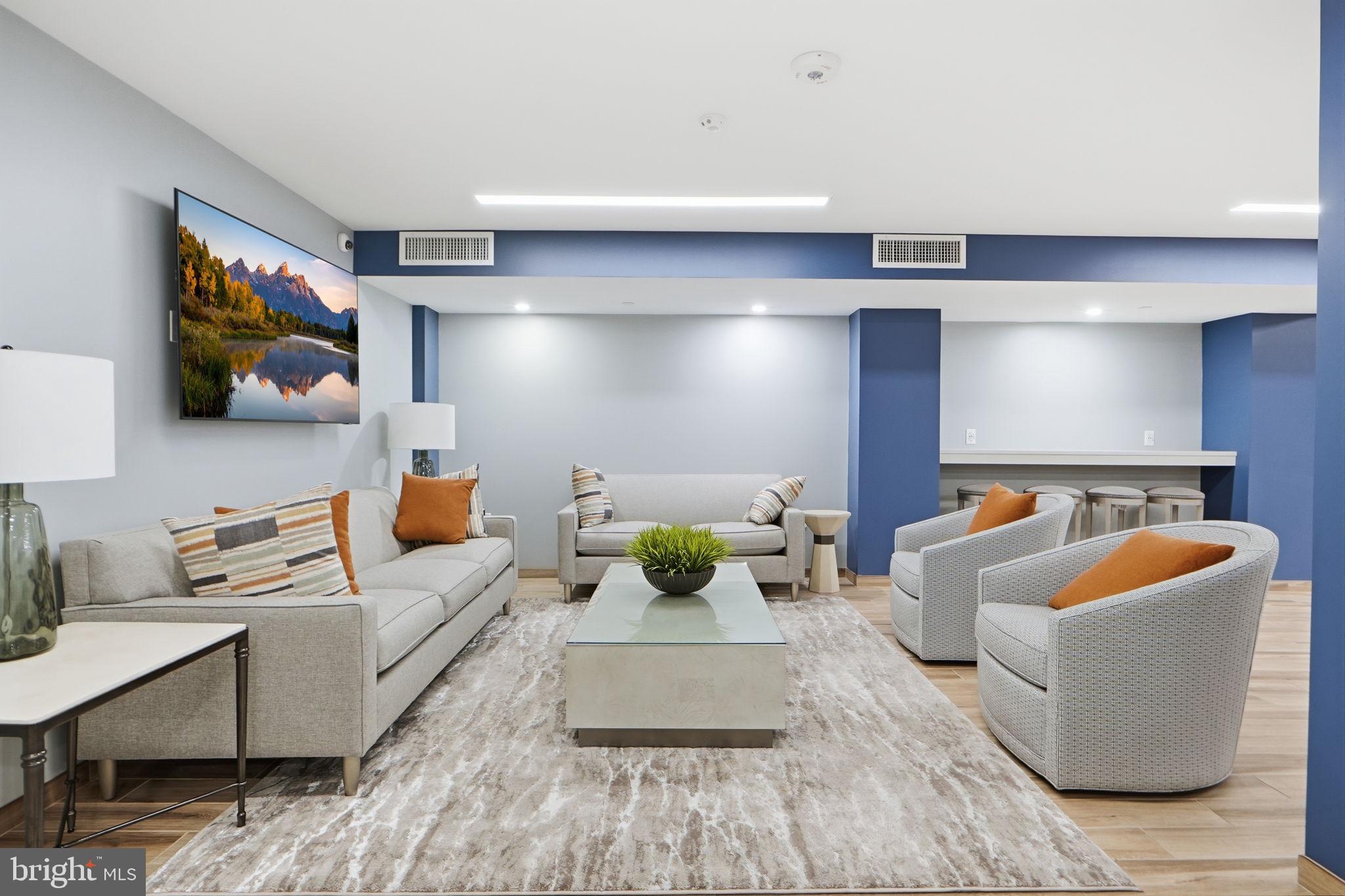 1808 Old Meadow Road, Unit 1201 McLean, VA 22102 - Photo 27 of 37 a living room with furniture and a flat screen tv