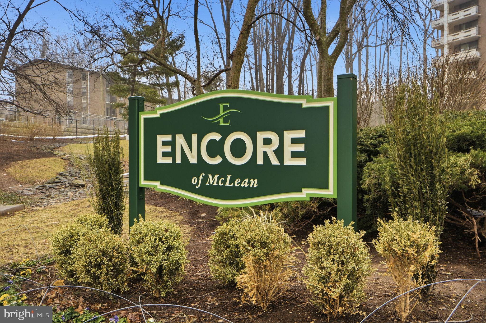 1808 Old Meadow Road, Unit 1201 McLean, VA 22102 - Photo 30 of 37 a sign broad in front of flowers