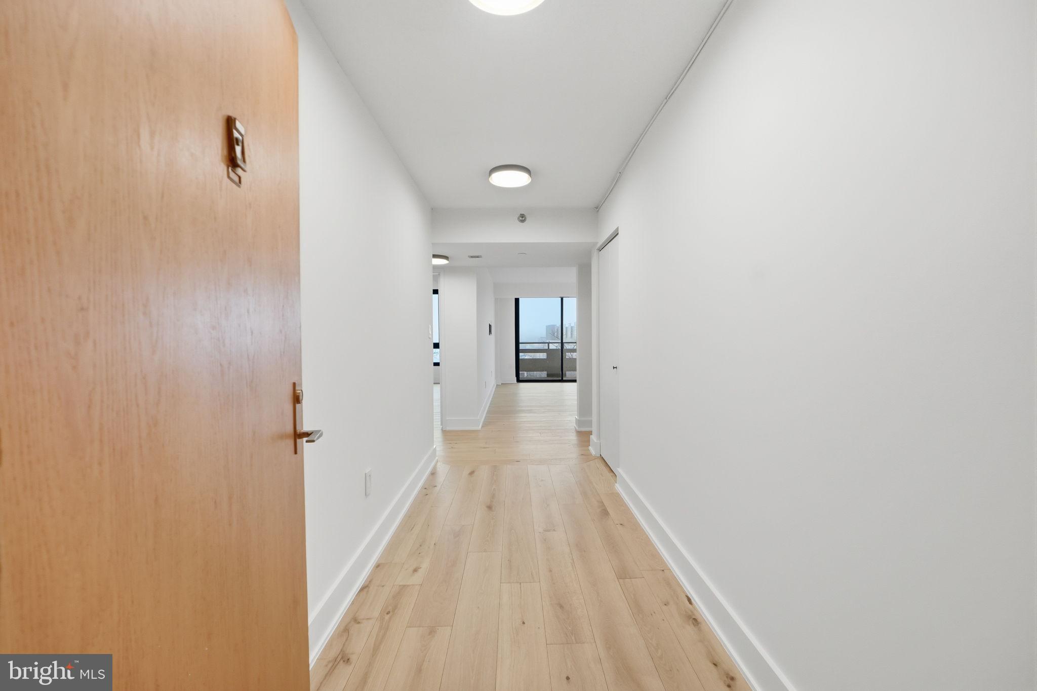 1808 Old Meadow Road, Unit 1201 McLean, VA 22102 - Photo 4 of 37 a view of a hallway with wooden floor