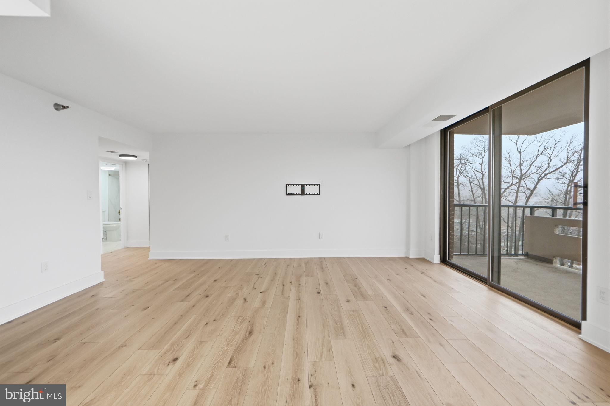 1808 Old Meadow Road, Unit 1201 McLean, VA 22102 - Photo 9 of 37 wooden floor in an empty room with a window