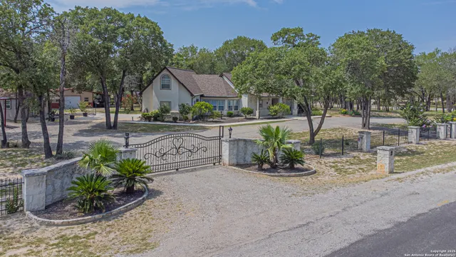 a view of a house with a yard and a street