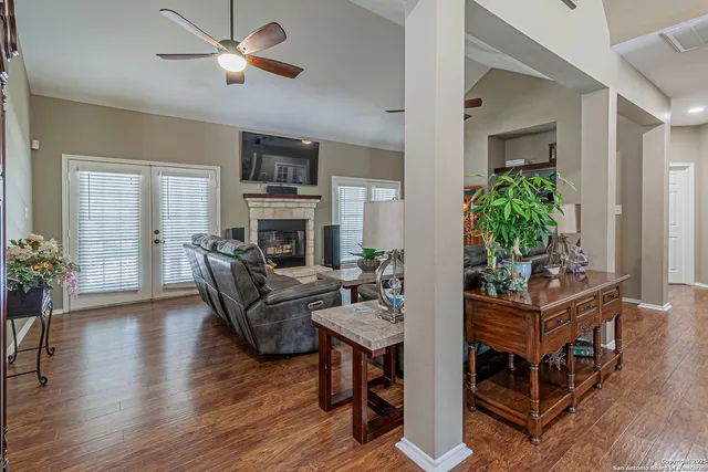 a kitchen with stainless steel appliances granite countertop a refrigerator a oven a sink a stove and a wooden floors